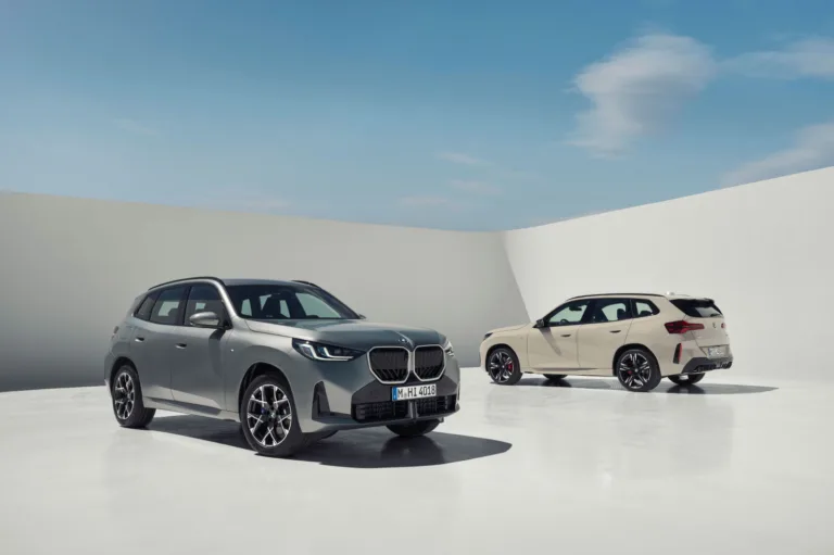 bmw x3 a couple of cars parked in a white room