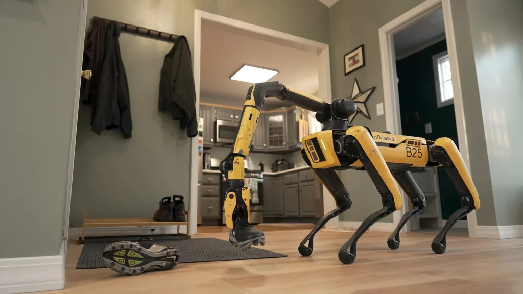 사진2 스팟이 바닥에 널브러진 신발을 집어 올리는 장면 https://mobilityground.com/wp-content/uploads/2026/04/사진2-스팟이-바닥에-널브러진-신발을-집어-올리는-장면.webp